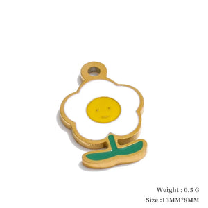 Fried egg-shaped pendant with a yellow center and green shadow on a white background