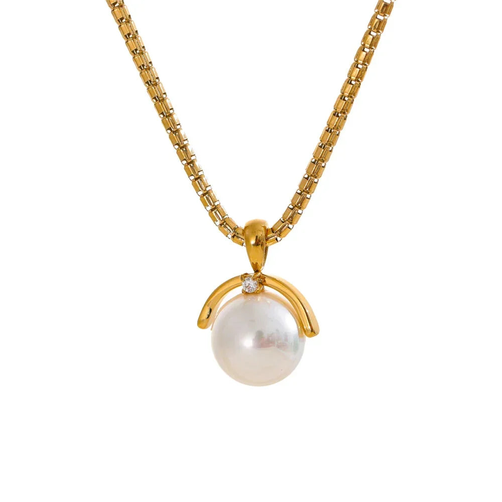 A silver stainless steel necklace with a large simulated pearl pendant, displayed on a white background.