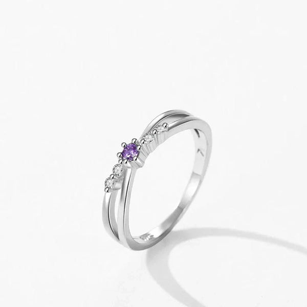 Silver ring with a purple gemstone on a white background