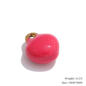 Pink heart-shaped charm with gold accent on a white background