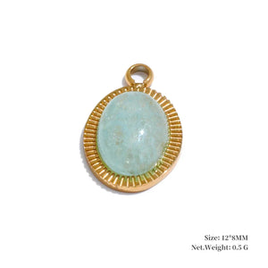 Gold-framed pendant with a light blue stone on a white background