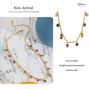 Gold necklace with colorful stones on a textured surface, labeled 'New Arrival' and 'NEW++'.