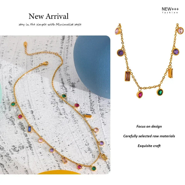 Gold necklace with colorful stones on a textured surface, labeled 'New Arrival' and 'NEW++'.