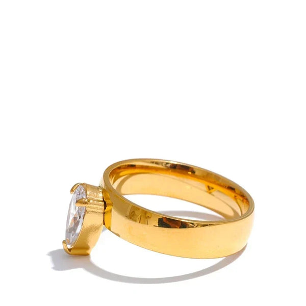 Gold ring with a diamond on a white background