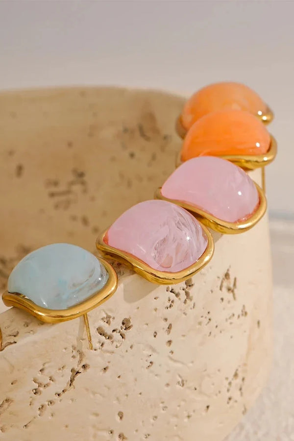 Jewelry with multicolored stones on a textured beige surface