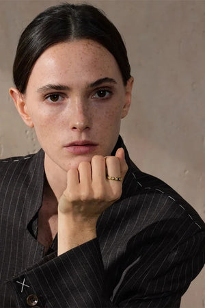 Person wearing a pinstripe suit with a neutral background
