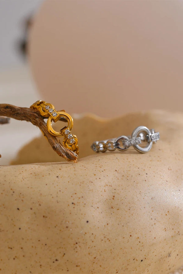 Gold and silver rings on a textured surface