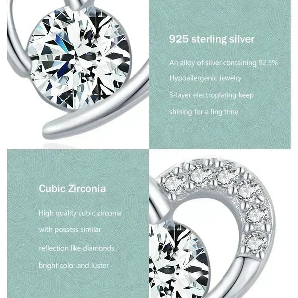 Silver earring with cubic zirconia stones on a light green background
