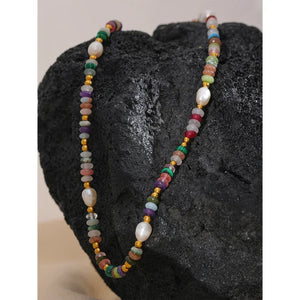 Multicolored beaded necklace on a dark stone surface-Nouveau Bohème Necklace - TM & CO. JEWELS 