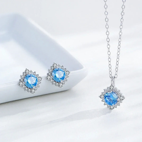 Jewelry set with blue gemstones on a white background