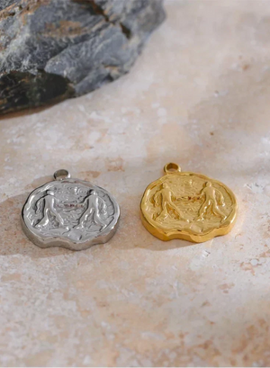 Gold and silver pendants on a stone surface