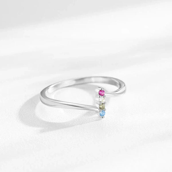 Silver ring with colorful gemstones on a white background