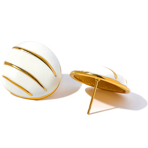 A pair of white oval stud earrings with gold metallic stripes, shown from two angles on a white background with a brand watermark at the bottom.