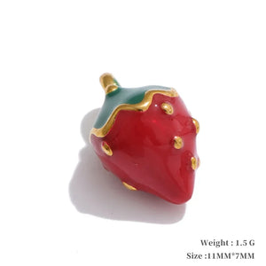 Red strawberry-shaped object with gold accents on a white background