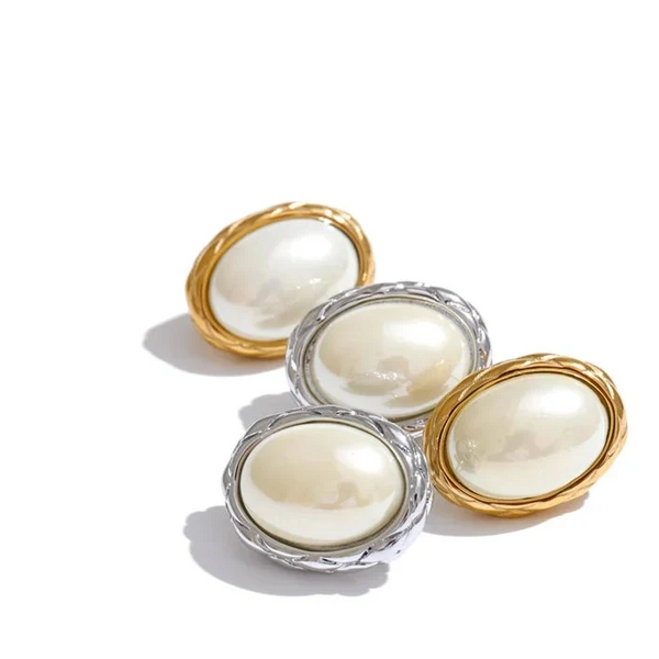 Set of four round candles with gold and silver holders on a white background