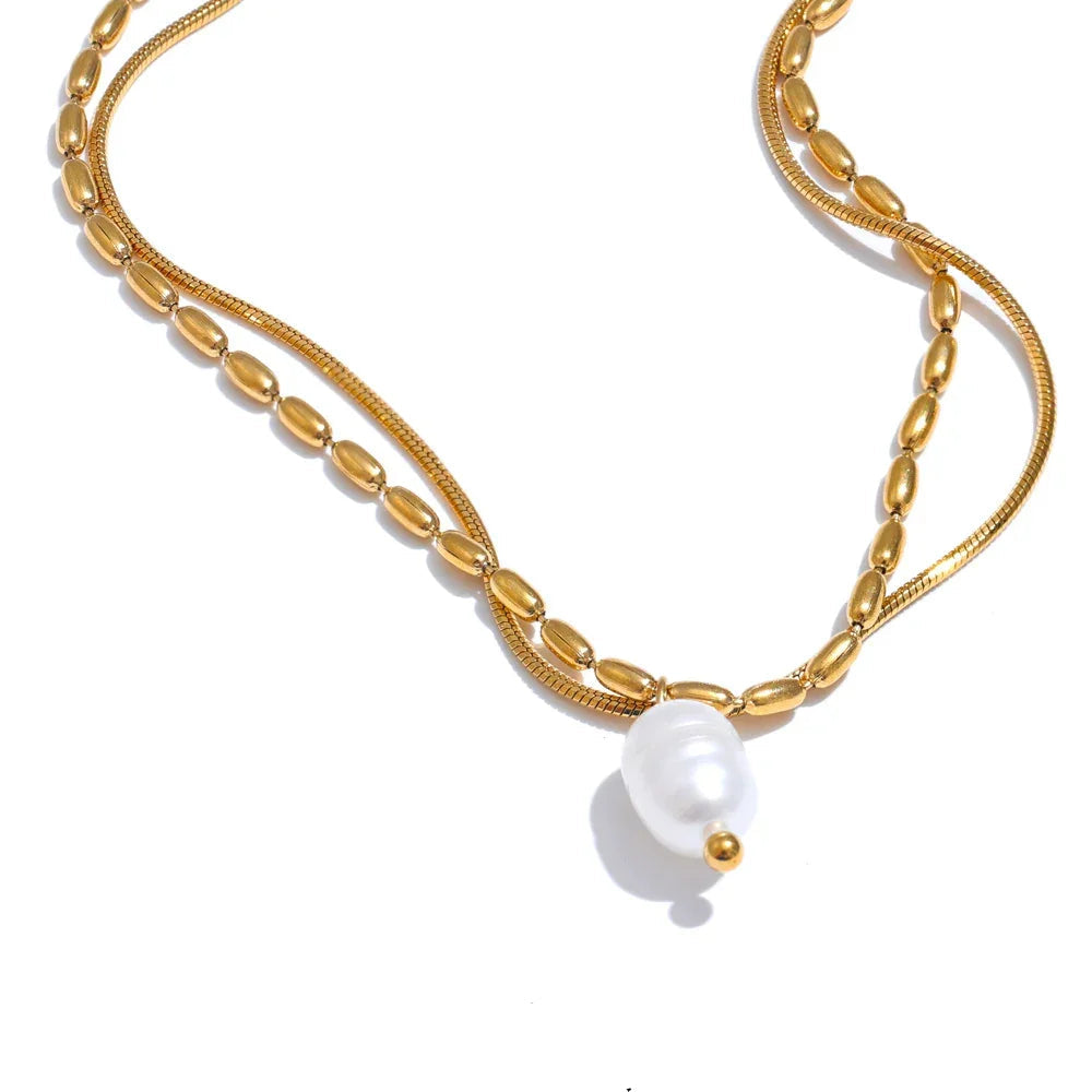Gold necklace with a pearl pendant on a white background,