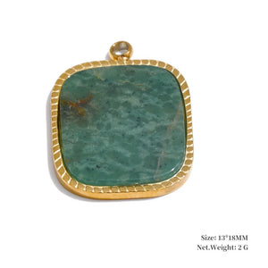 Green stone pendant with gold frame on a white background