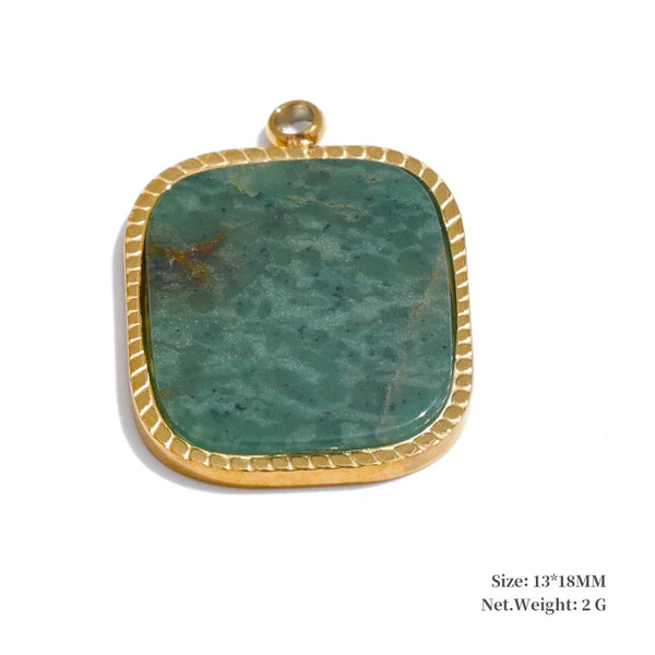 Green stone pendant with gold frame on a white background