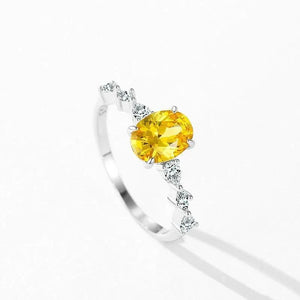 Amber Luxe Engagement Ring - TM & CO. JEWELS - Ring with a yellow gemstone and diamond accents on a white background.