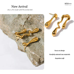 Gold earrings on a stone surface with 'NEW++' branding and text about design and craftsmanship.