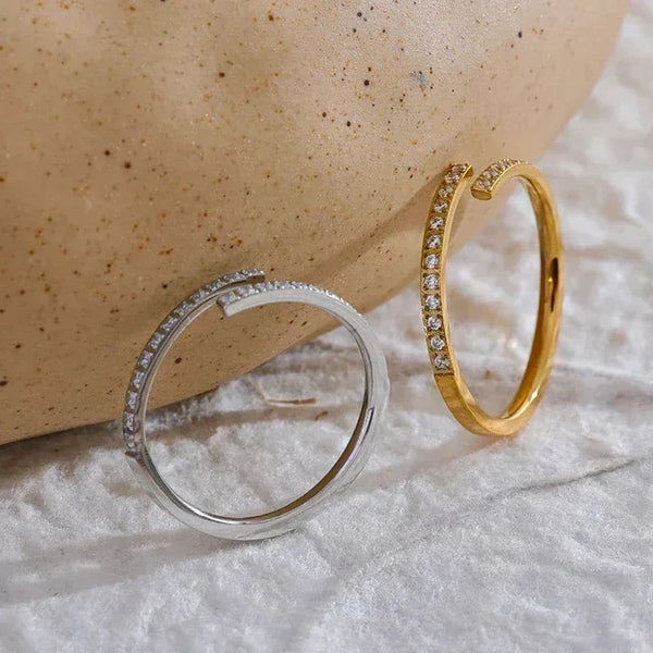 Gold and silver open rings with small crystals, minimalist jewelry on textured fabric