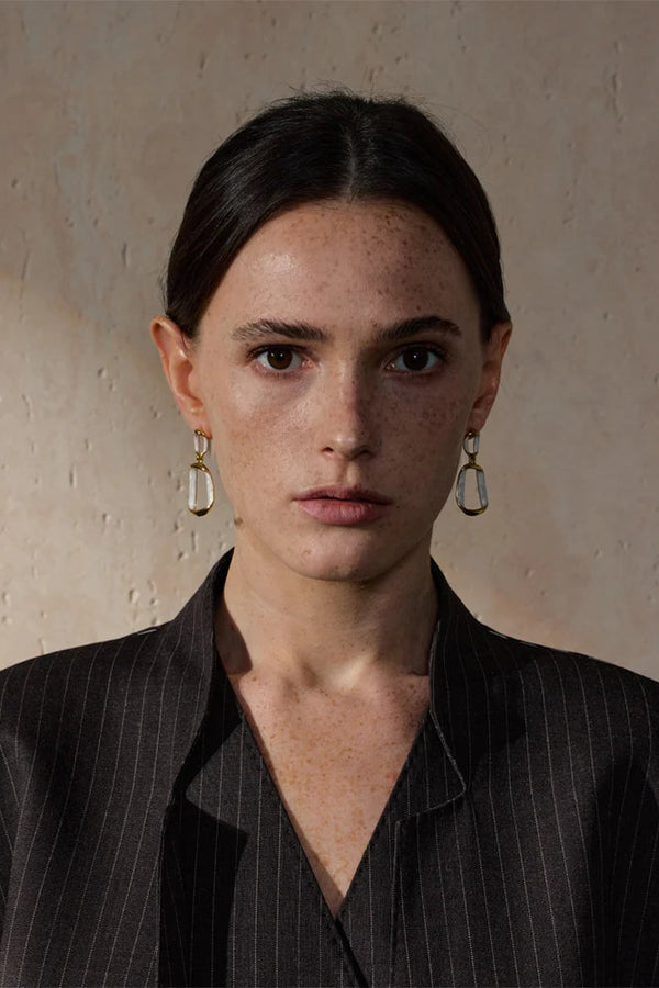 Woman wearing a black pinstripe shirt with a neutral background