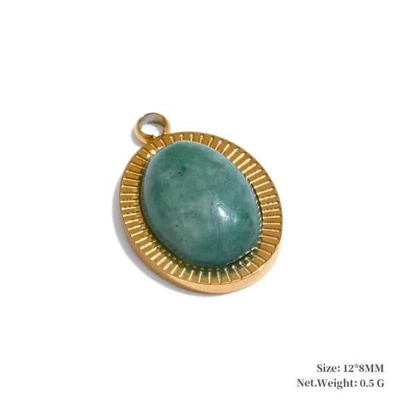 Gold pendant with a green stone on a white background