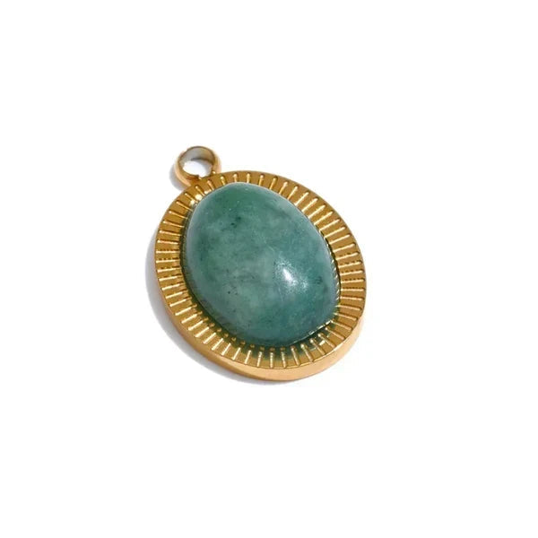 Gold pendant with a green stone on a white background