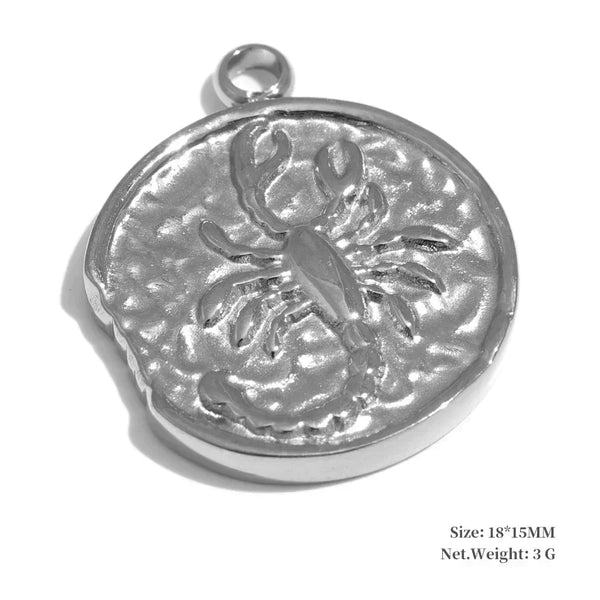 Silver pendant with a detailed design on a white background