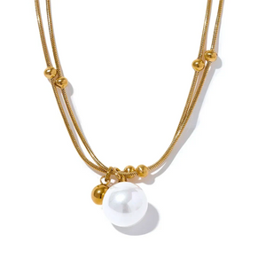 Gold necklace with a pearl pendant on a white background