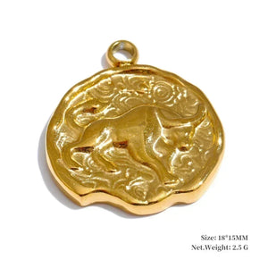 Gold pendant with engraved design on a white background
