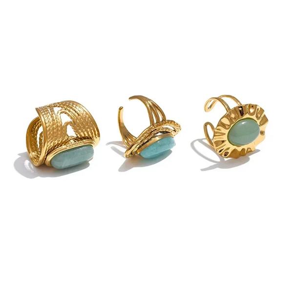 Three gold and turquoise earrings on a white background