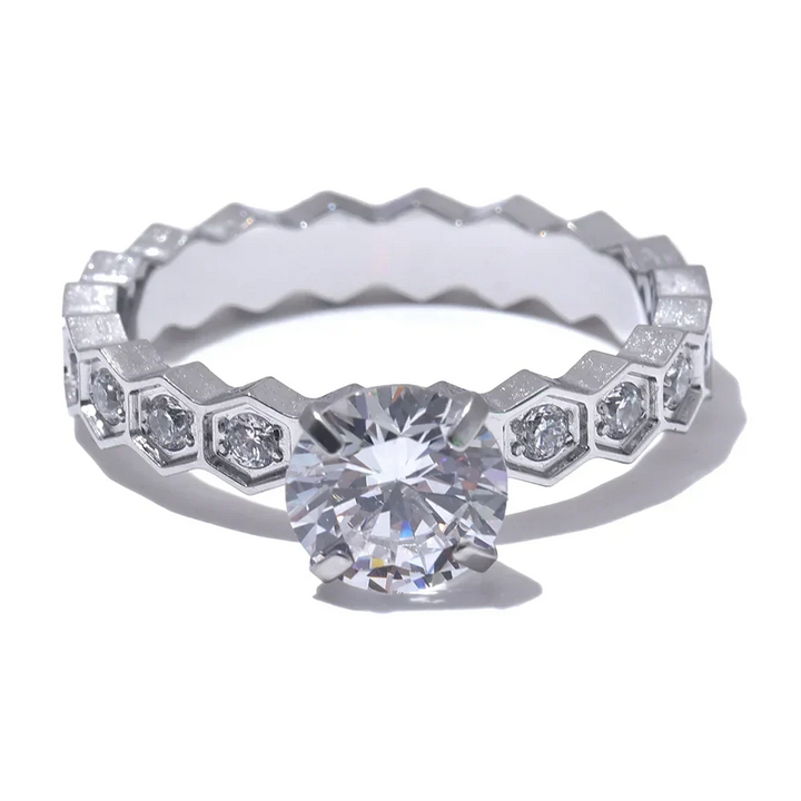 Diamond ring with a hexagonal setting on a white background