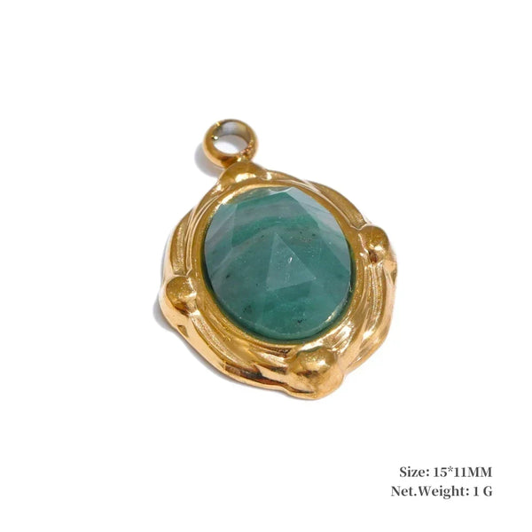 Gold pendant with a green gemstone on a white background