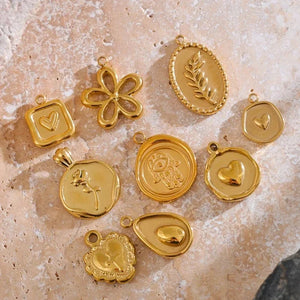 Gold pendants on a textured stone surface