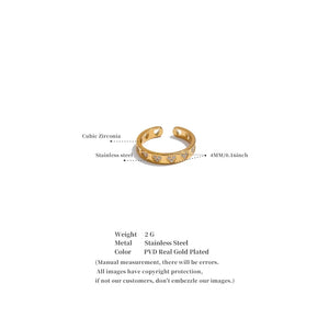 Gold ring with embedded stones on a white background