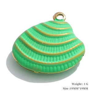 Green shell-shaped pendant with gold accents on a white background