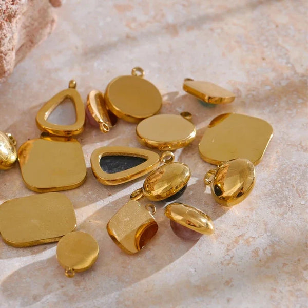 Gold jewelry components on a textured surface
