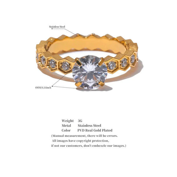 Gold ring with a large central gemstone and smaller stones on a white background
