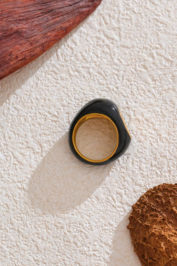Black ring with gold interior on textured white surface, with 'SCENE DRAWING' text at the top.