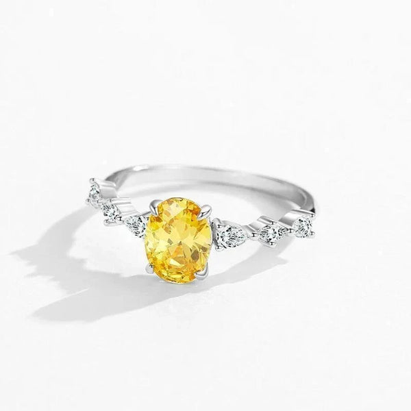 Amber Luxe Engagement Ring - TM & CO. JEWELS - Ring with a yellow gemstone and diamond accents on a white background.