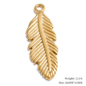 Gold feather-shaped pendant on a white background