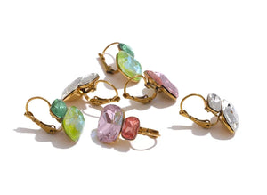 Set of colorful gemstone earrings on a white background