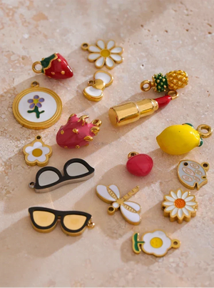 Collection of colorful charms on a textured beige surface
