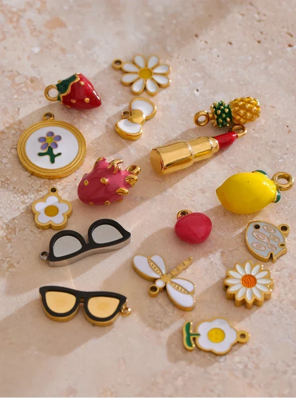 Collection of colorful charms on a textured beige surface