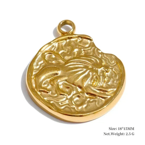 Gold pendant with a lion design on a white background
