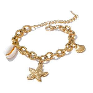 Gold chain bracelet with starfish and shell charms on a white background