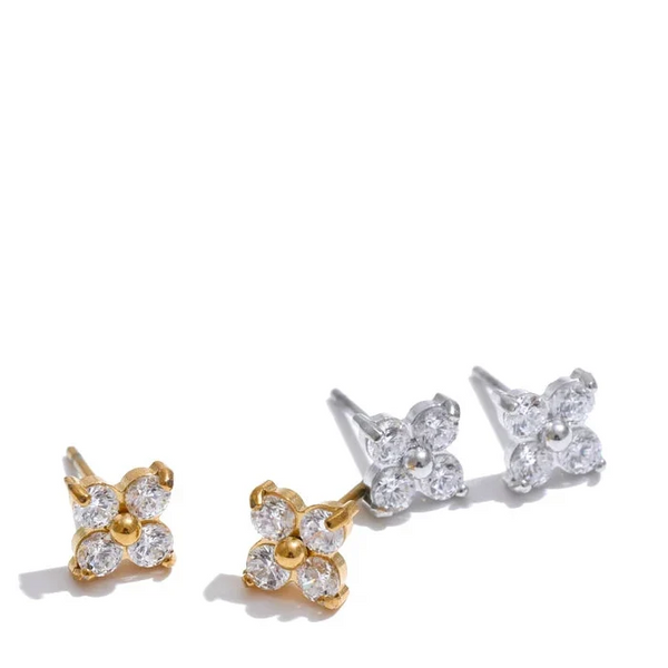 Pair of gold and silver floral earrings on a white background