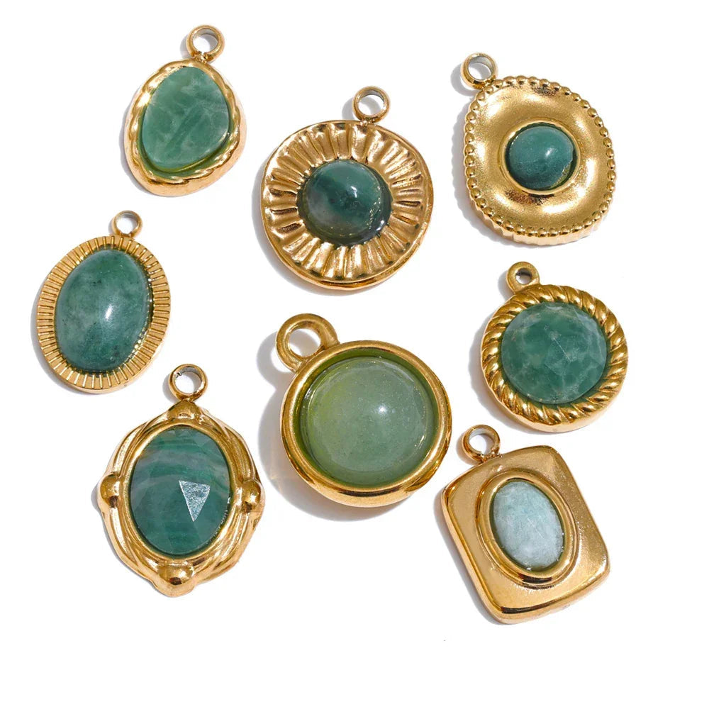 Gold-framed green gemstone pendants on a white background .