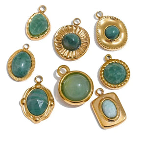 Gold-framed green gemstone pendants on a white background